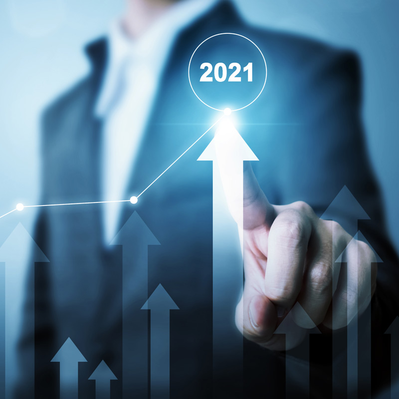 A graph showing a man pointing at 2021 and an up arrow showing growth in 2021