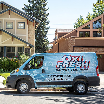 An Oxi Fresh Carpet Cleaning van arrives at a customer's home.