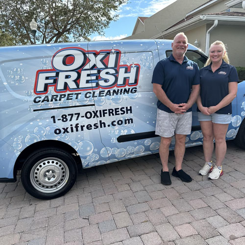 This photo shows Will Chambers and his partner standing in front of an Oxi Fresh van.