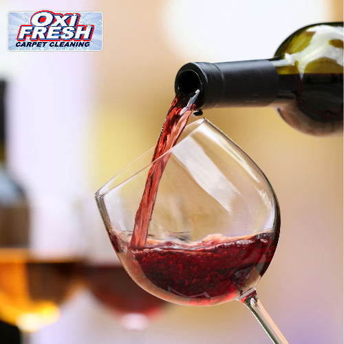 This image shows a bottle of red wine pouring into a tilted, stemmed wine glass and features the Oxi Fresh logo in the upper-left corner.